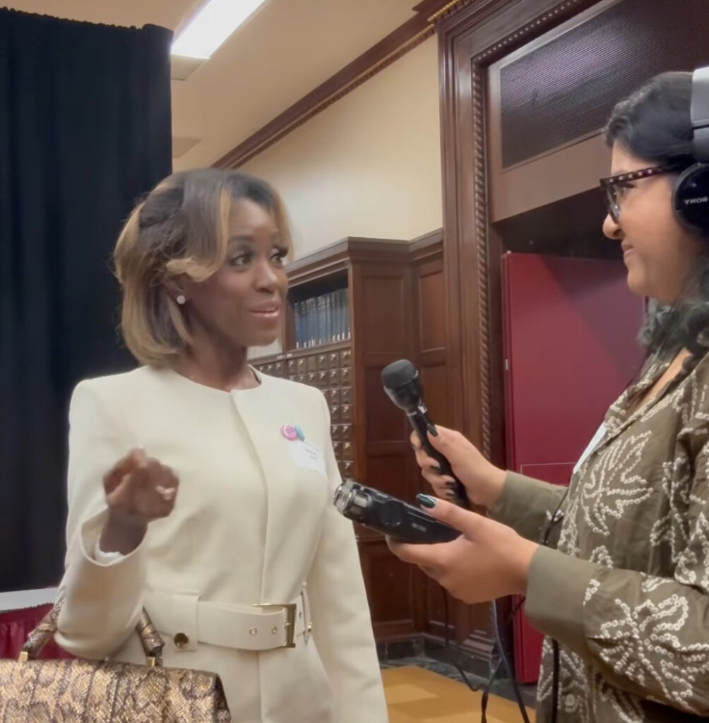Muskaan interviewing an attendee at the conference.