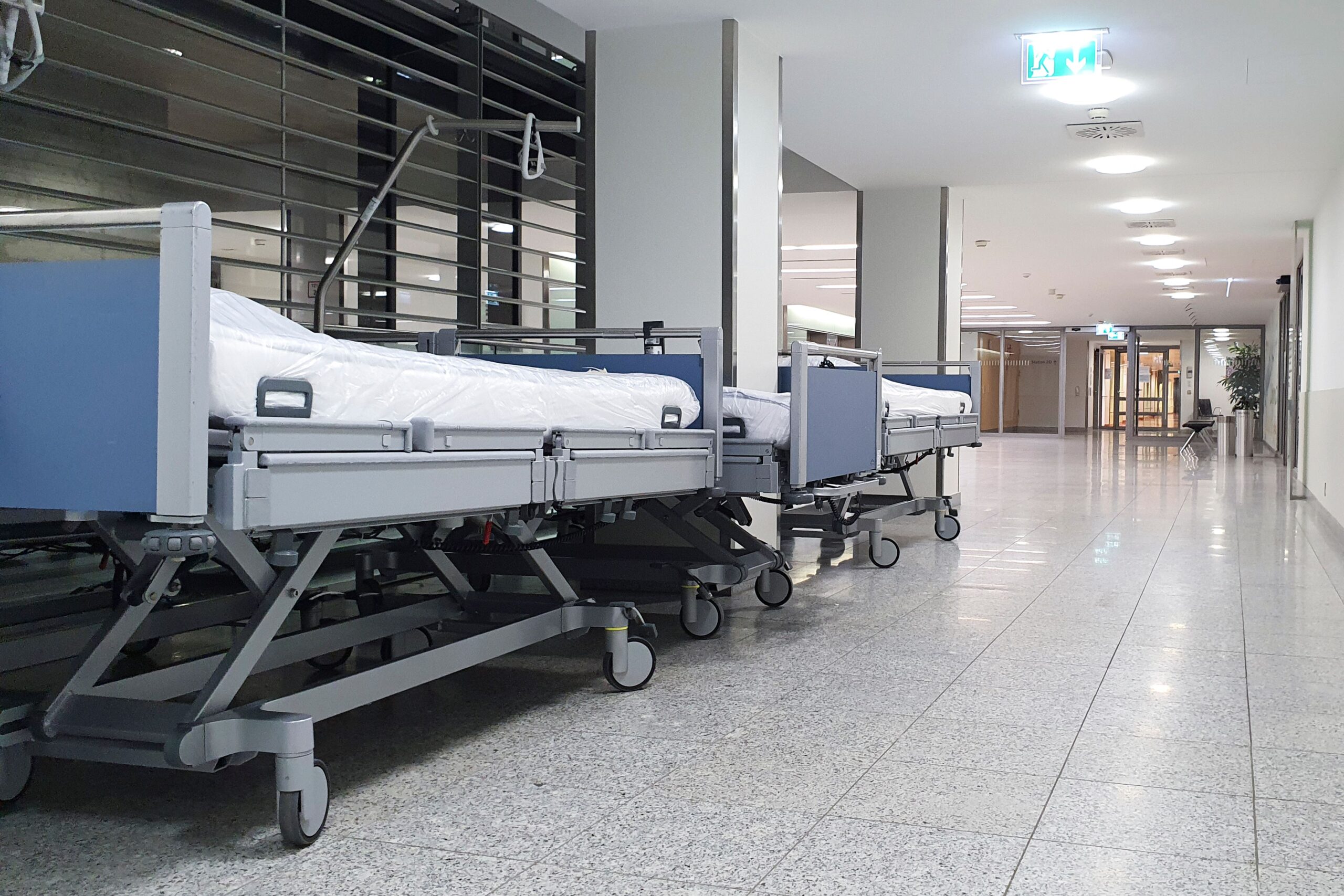 an empty hospital hallway with stretchers